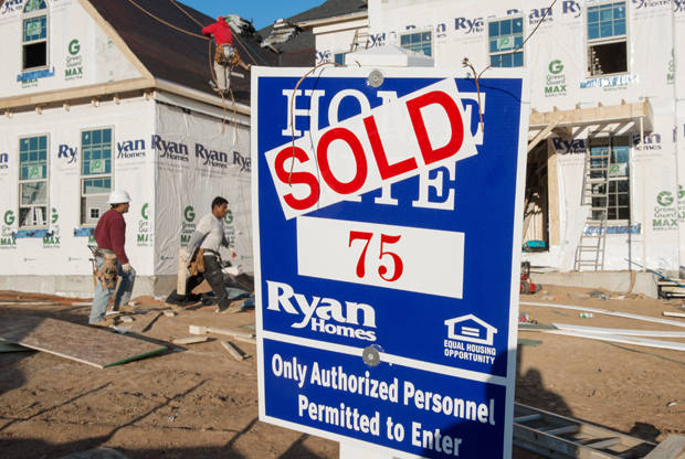 Construction workers build a new home November 20, 2014 in Ashburn, Virginia. 