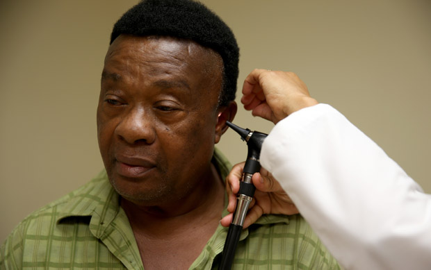 This 2014 photo shows Felue Chang receiving a checkup at the South Broward Community Health Services clinic in Hollywood, Florida.