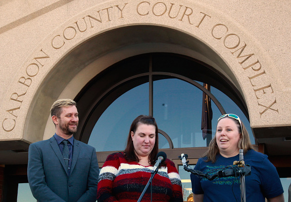 Troy Williams, left, the Executive Director of Equality Utah, April Hoagland, center, and her wife Beckie Peirce, right, talk to the press after a Utah juvenile judge amended an order to remove the couple's foster child from their home on Nov. 13 in Price, Utah.