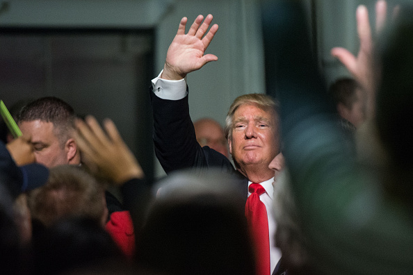 Trump waves to the crowd at a Pearl Harbor Day Rally at the U.S.S. Yorktown in Mount Pleasant, South Carolina, on Monday.