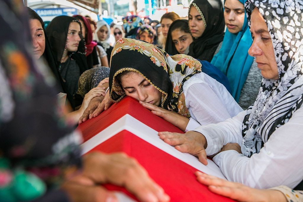 A woman lays her head on the coffin of a victim of the failed July 15 coup attempt during his funeral in Istanbul on July 17, 2016.
