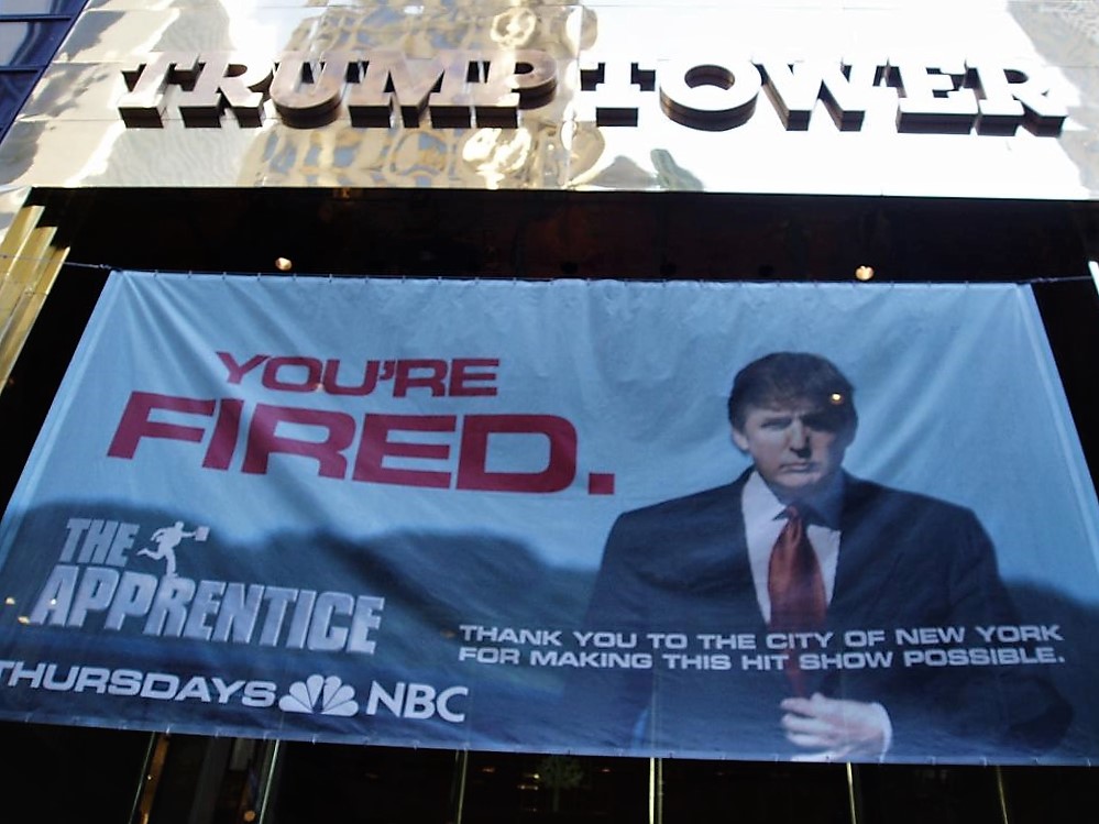 A photo from 2005 shows a banner advertising The Apprentice hanging outside Trump Tower. 