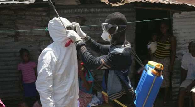 Health workers suit up in protective clothing (PPE), before taking people suspected of having Ebola to a re-opened Ebola holding center in the West Point neighborhood on October 17, 2014 in Monrovia, Liberia. The World Health Organization says that more than 4,500 people have died due to the Ebola epidemic in West Africa with a 70 percent mortality rate for those infected with the virus. 