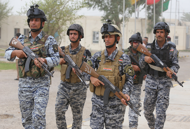 Iraqi policemen are seen inside a military base in the capital Baghdad, on June 11, 2014, after the parliament had received a joint request from Iraqi Prime Minister Nuri al-Maliki and the president's office to declare a state of emergency. Jihadists seized in the city of Mosul, Iraq's second and Nineveh province on June 10, in a major blow to the government apparently unable to halt the progress of armed.  